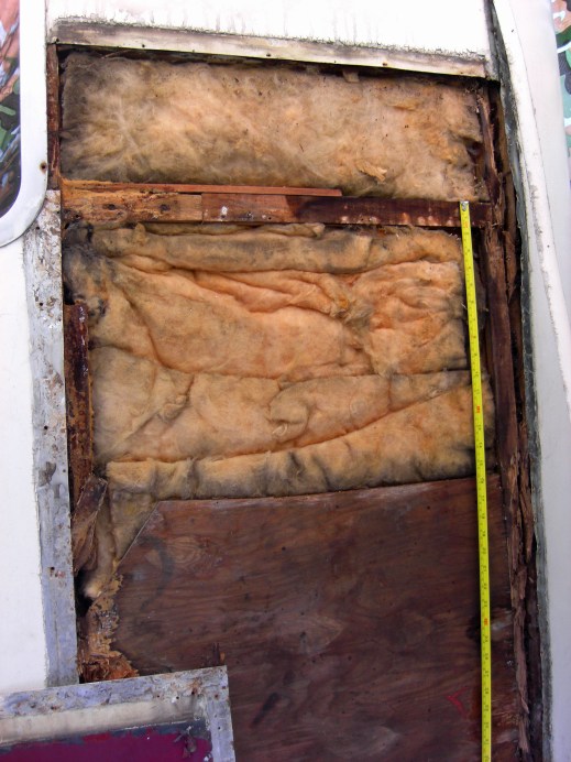 The first panel is removed to reveal wet fibreglass and rotten wood...but no asbestos!