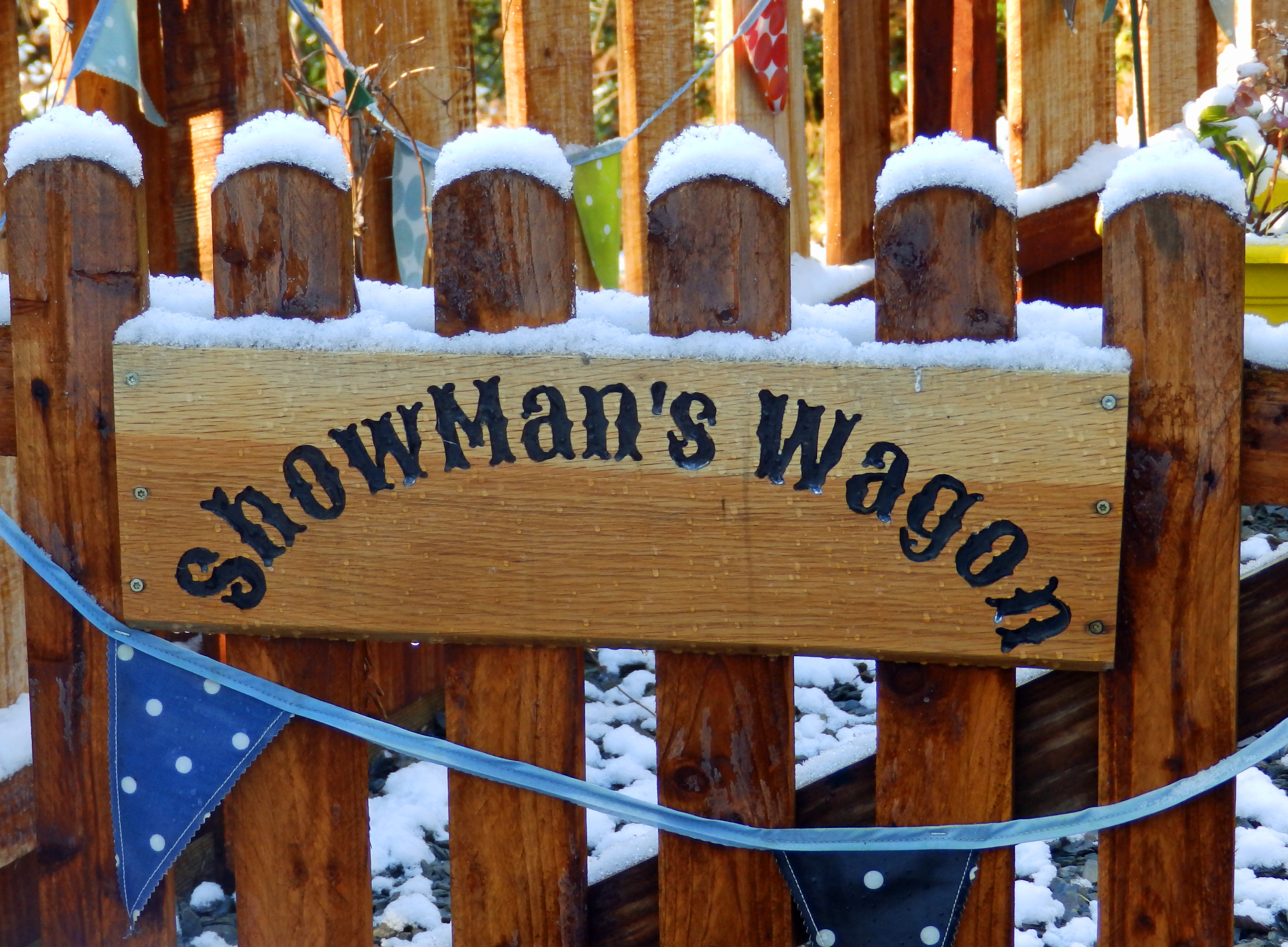 Snow-covered sign on the gate