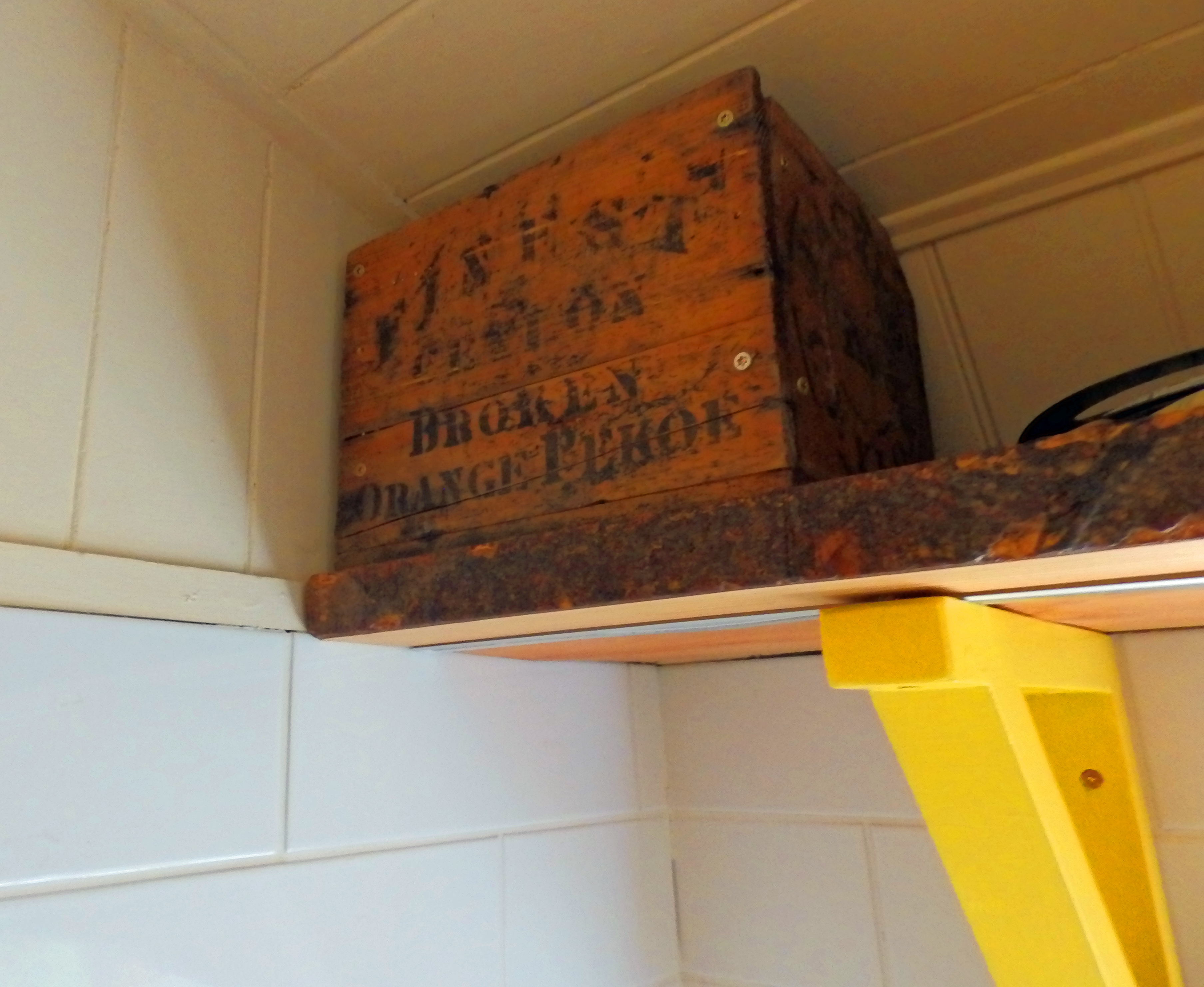An old tea box on the kitchen shelf